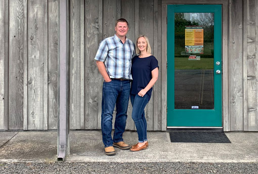 Ryan and Brandi Helligso in front of office